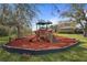 Community playground equipment, including slides and climbing structures, is surrounded by trees and open space at 2515 130Th E Ave, Parrish, FL 34219