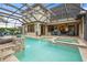 Landscaped pool and spa with covered lanai, ideal for relaxation and outdoor entertaining at 2515 130Th E Ave, Parrish, FL 34219