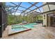 Beautiful screened-in pool area with spa and outdoor dining area, perfect for relaxation and outdoor entertaining at 2515 130Th E Ave, Parrish, FL 34219