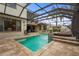 Inviting pool and patio with water feature and covered lanai, perfect for outdoor enjoyment and relaxation at 2515 130Th E Ave, Parrish, FL 34219