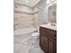 Well-lit bathroom with bath tub, shower, vanity, and tiled floors at 2525 22Nd St, Sarasota, FL 34234