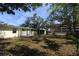 Spacious backyard features a lush lawn, patio table, and screened in porch perfect for outdoor entertaining at 2696 Loma Linda St, Sarasota, FL 34239