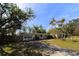 Charming single-story home with a welcoming front porch and mature landscaping at 2696 Loma Linda St, Sarasota, FL 34239
