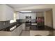 Stylish kitchen featuring stainless steel appliances, granite countertops, and white cabinetry at 2696 Loma Linda St, Sarasota, FL 34239