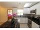 Updated kitchen with stainless steel appliances, granite counters, and bright white cabinets at 2696 Loma Linda St, Sarasota, FL 34239