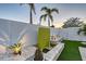 Backyard featuring a modern water feature, lush landscaping, and manicured grounds at 309 Avenida Milano, Sarasota, FL 34242