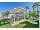 Inviting backyard patio with outdoor dining area featuring pergola, lush landscaping, and privacy fence at 309 Avenida Milano, Sarasota, FL 34242