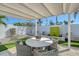 Serene backyard patio with a pergola-shaded dining area and well-maintained landscaping for outdoor relaxation at 309 Avenida Milano, Sarasota, FL 34242