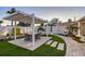 Charming backyard patio featuring a covered dining area, lush landscaping, and stone walkway at 309 Avenida Milano, Sarasota, FL 34242
