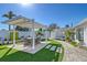 Landscaped backyard features a covered outdoor dining area and lush greenery at 309 Avenida Milano, Sarasota, FL 34242
