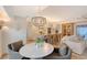 Open-concept dining area features modern chandelier lighting, leading into the spacious gourmet kitchen at 309 Avenida Milano, Sarasota, FL 34242