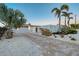 Front yard with a long driveway leading to the garage and a beautiful garden at 309 Avenida Milano, Sarasota, FL 34242