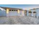Garage with a paved driveway and decorative accents; enhanced by landscape lighting at 309 Avenida Milano, Sarasota, FL 34242