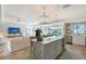 Open-concept kitchen featuring a large island, modern appliances, and stylish pendant lighting at 309 Avenida Milano, Sarasota, FL 34242