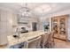 Open kitchen features a large kitchen island with seating, modern lighting, and stainless-steel appliances at 309 Avenida Milano, Sarasota, FL 34242