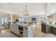 Open-concept kitchen features a large island, stainless steel appliances, and stylish light fixtures at 309 Avenida Milano, Sarasota, FL 34242