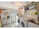 Bright laundry room with modern washer and dryer and lots of storage at 309 Avenida Milano, Sarasota, FL 34242
