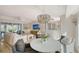 A living room with a white sofa, stylish decor, and a direct view to the home's dining and kitchen spaces at 309 Avenida Milano, Sarasota, FL 34242