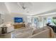 Bright living room with white furnishings, a modern ceiling fan, and access to the outdoors at 309 Avenida Milano, Sarasota, FL 34242