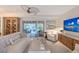 Bright living room featuring white furnishings, a decorative ceiling fan, and seamless indoor/outdoor living at 309 Avenida Milano, Sarasota, FL 34242