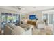 Bright living room with white furnishings, a modern ceiling fan, and access to an outdoor patio at 309 Avenida Milano, Sarasota, FL 34242