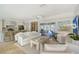 Open-concept living room flowing into a modern kitchen and leading to an outdoor patio at 309 Avenida Milano, Sarasota, FL 34242