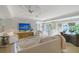 Bright living room with white furnishings, a modern ceiling fan, and access to the outdoors at 309 Avenida Milano, Sarasota, FL 34242
