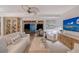 Cozy living room with access to a covered patio, a modern ceiling fan, and comfortable seating at 309 Avenida Milano, Sarasota, FL 34242