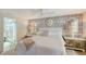 Bright bedroom features serene wallpaper, white linens, and spa-like ensuite bathroom at 309 Avenida Milano, Sarasota, FL 34242