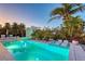 Picturesque pool area with in-pool loungers and a serene spa surrounded by palm trees at 309 Avenida Milano, Sarasota, FL 34242