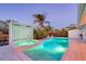 Sparkling pool and hot tub surrounded by lush greenery and modern outdoor structures at 309 Avenida Milano, Sarasota, FL 34242