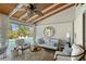 Relaxing sunroom featuring comfortable lounge seating, pool views, and ceiling fans at 309 Avenida Milano, Sarasota, FL 34242