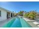 Expansive swimming pool and spa extends along the exterior of the house creating seamless indoor/outdoor living at 309 Avenida Milano, Sarasota, FL 34242