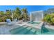 Tranquil pool area with lounge seating, jacuzzi and well manicured landscaping at 309 Avenida Milano, Sarasota, FL 34242
