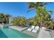 Luxury pool featuring built-in sunbeds and vibrant greenery, perfect for relaxation and entertainment at 309 Avenida Milano, Sarasota, FL 34242