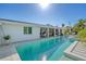 Spacious backyard featuring a sparkling pool and a covered outdoor living area with comfortable seating at 309 Avenida Milano, Sarasota, FL 34242