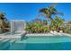 Beautiful pool and spa with integrated sun loungers, tropical foliage creating a private backyard oasis at 309 Avenida Milano, Sarasota, FL 34242