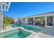 Stunning pool and outdoor patio with a view of the water creating a perfect spot for entertaining and relaxation at 309 Avenida Milano, Sarasota, FL 34242