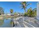 Waterfront patio with lounge chairs and access to canal, offering a serene outdoor experience at 309 Avenida Milano, Sarasota, FL 34242