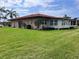 Lush green backyard with mature landscaping and well-maintained lawn, complemented by a terracotta tiled roof at 3113 Cambridge Ave # 3113, Bradenton, FL 34207