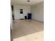 Spacious garage with a white door, trash containers, and ample parking at 3113 Cambridge Ave # 3113, Bradenton, FL 34207