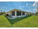 Well-maintained backyard featuring a screened lanai and lush green lawn at 3335 Brooklyn Ave, Port Charlotte, FL 33952