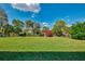 Spacious backyard with lush green lawn and serene pond view at 3335 Brooklyn Ave, Port Charlotte, FL 33952