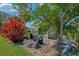 Scenic backyard view with mature trees, lush grass, and a pond at 3335 Brooklyn Ave, Port Charlotte, FL 33952