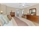 Bright bedroom with a ceiling fan, wood floors, and a view of the bathroom at 3335 Brooklyn Ave, Port Charlotte, FL 33952