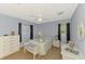 Bedroom with light blue walls, ceiling fan, and white wicker furniture at 3335 Brooklyn Ave, Port Charlotte, FL 33952