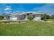 Charming single-story home with a well-manicured lawn and neutral-colored exterior at 3335 Brooklyn Ave, Port Charlotte, FL 33952