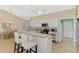 Well-lit kitchen featuring a breakfast bar, modern appliances, and a seamless transition to dining area at 3335 Brooklyn Ave, Port Charlotte, FL 33952