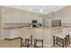 Stylish kitchen with white cabinets, stainless steel appliances, a breakfast bar and modern countertops at 3335 Brooklyn Ave, Port Charlotte, FL 33952