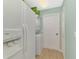 Bright laundry room features a stacked washer and dryer and a full-size refrigerator at 3335 Brooklyn Ave, Port Charlotte, FL 33952